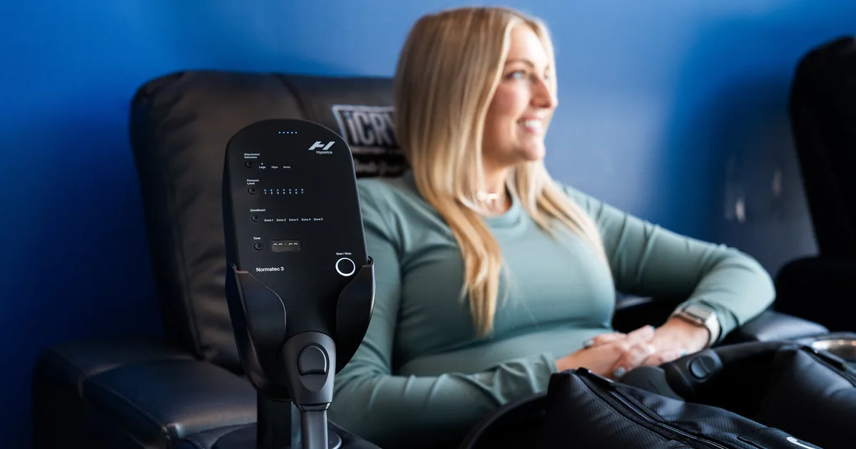 Runner relaxing during compression therapy for recovery at iCRYO Daniel Island