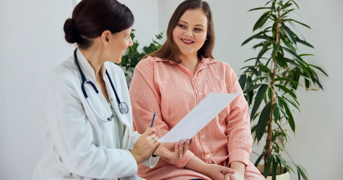 Provider measuring a patient's waist during a medical weight loss consultation at iCRYO Daniel Island